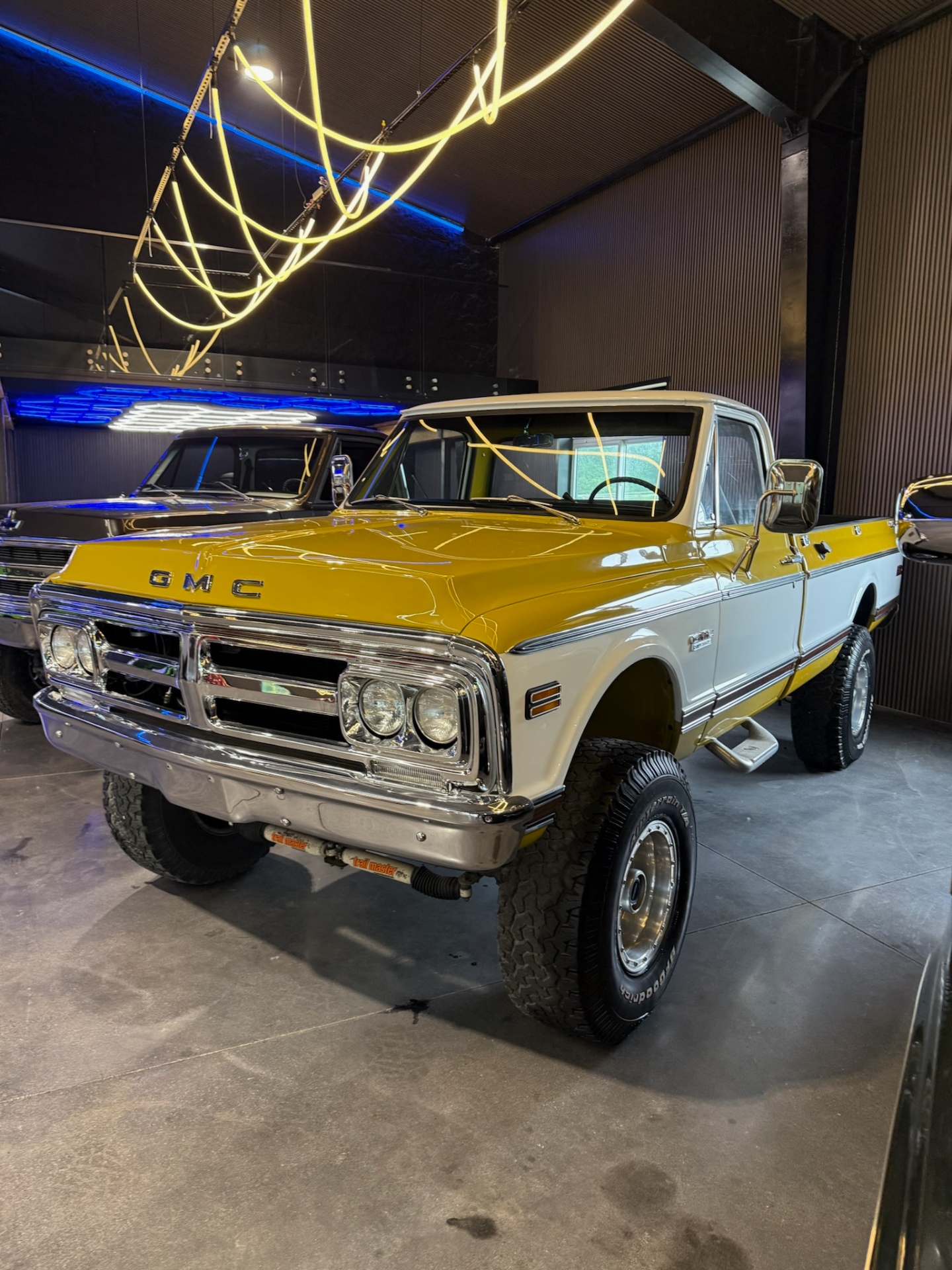 Gold and white GMC truck in showroom