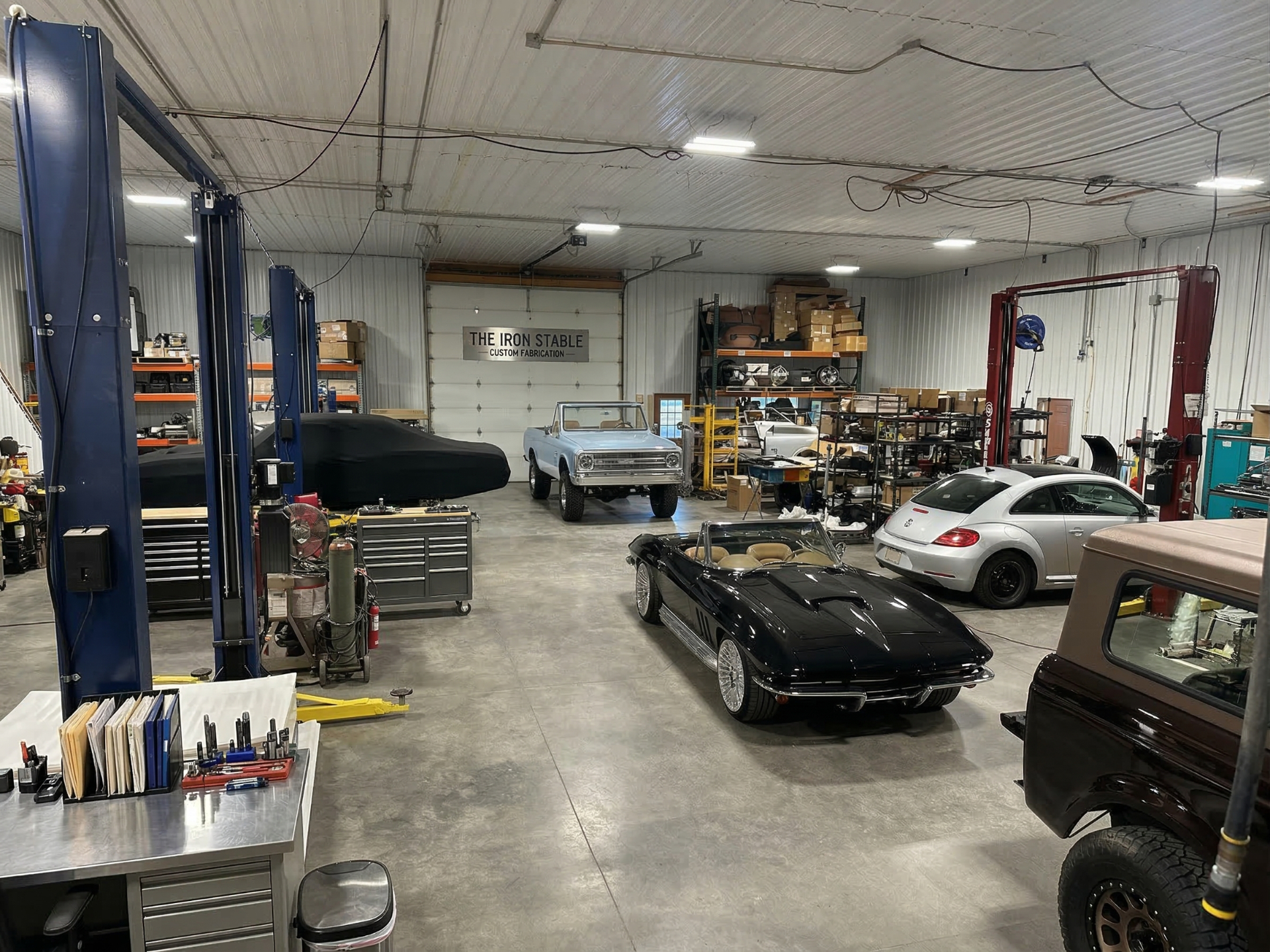 Main garage with vehicles and lifts