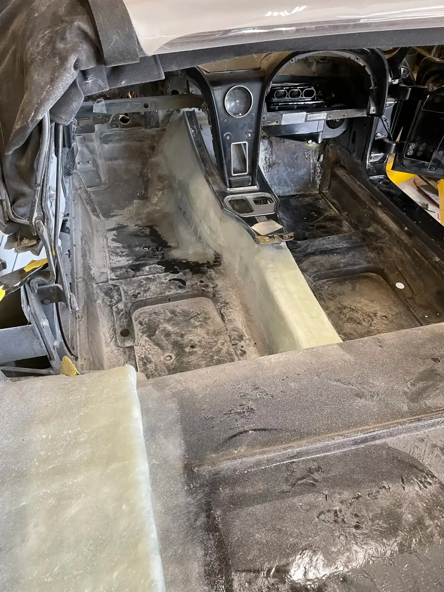 Full interior teardown showing bare floor and console