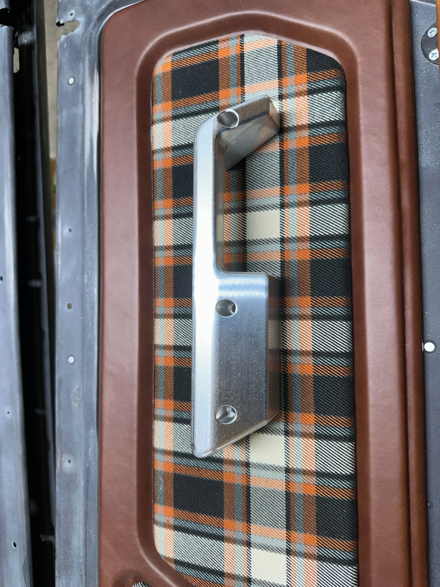 Leather door panel with plaid fabric insert