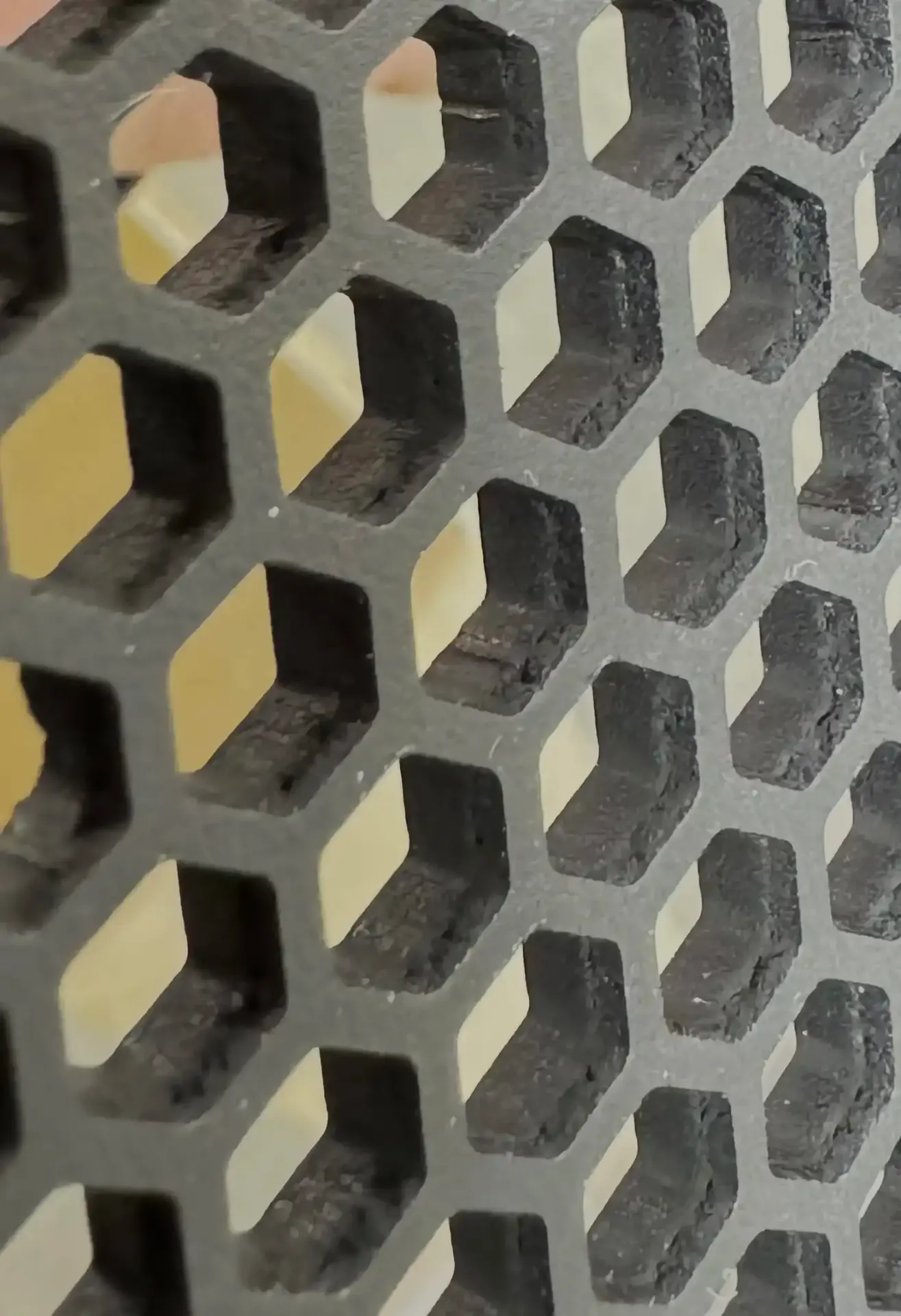 Macro detail of honeycomb speaker grille pattern